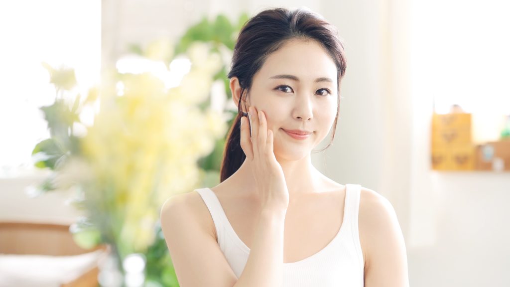 a woman touching her bare face
