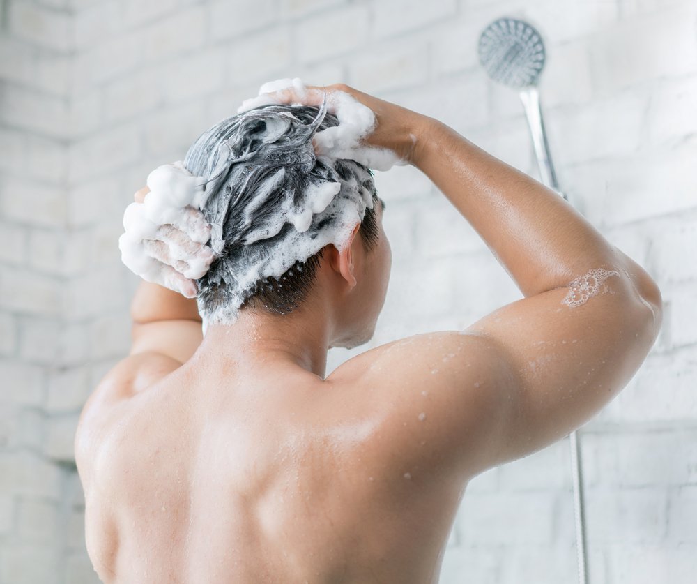 Man washing his hair in the shower