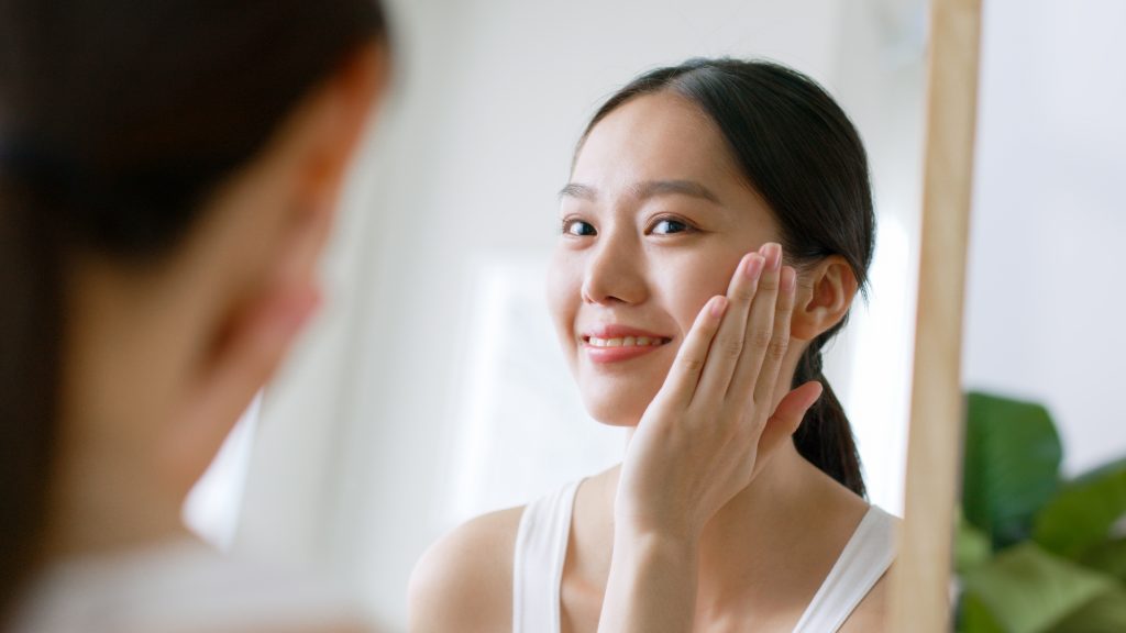 a woman smiling on the mirror