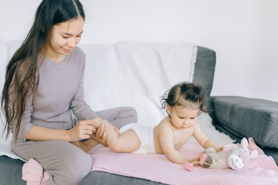 Putting Lotion on Newborn