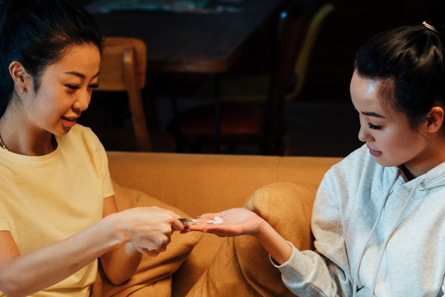 women applying lotion