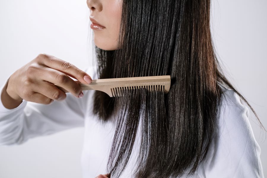woman combing her hair