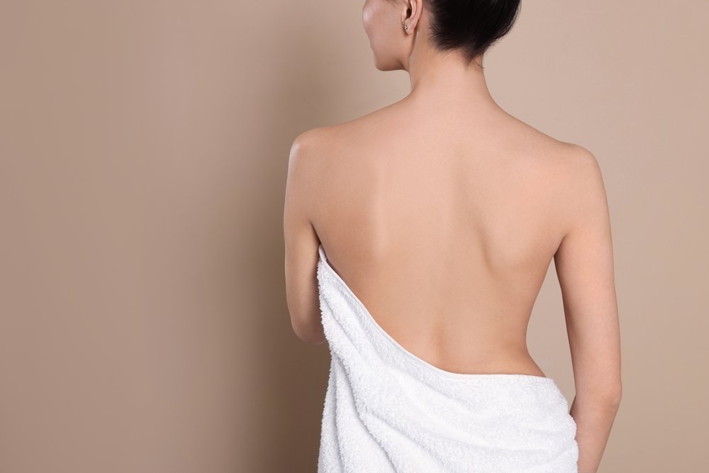 Back,View,Of,Woman,With,Perfect,Smooth,Skin,On,Beige