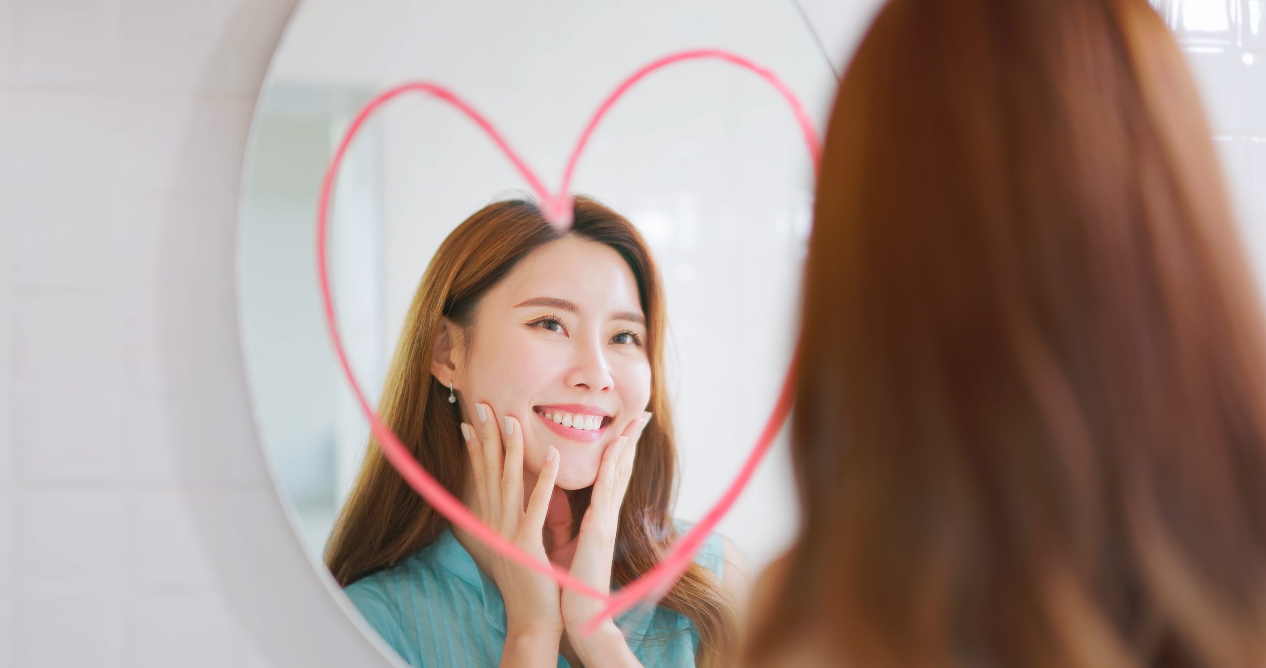a woman looking at herself on the mirror