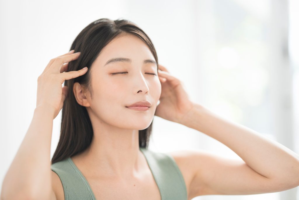 a woman massaging her hair