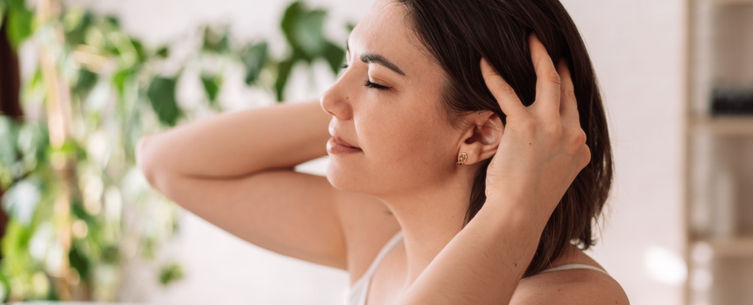 a woman massaging her hair